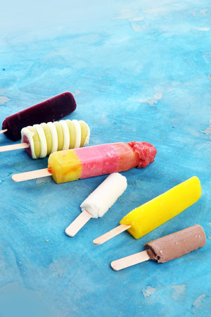 Colorful popsicle or Vanilla frozen yogurt or soft ice cream