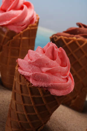 Vanilla frozen yogurt or soft ice cream in waffle cone. icecream with chocolate, strawberry and vanillaの写真素材
