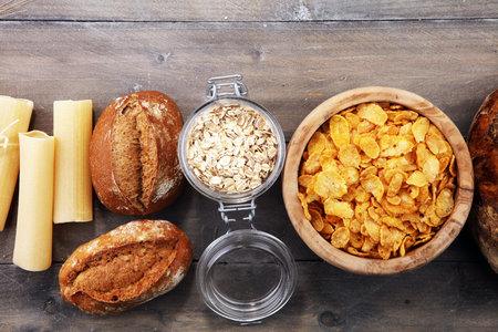 whole grain products with complex carbohydrates on rustic background