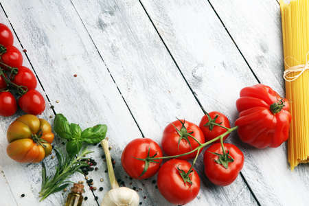 Various types of tomatoes on vintage background. italian food concept with tomatoesの写真素材