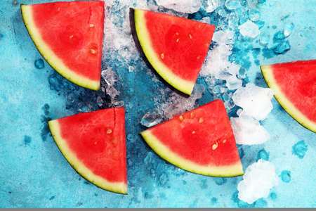 watermelon on blue background. juicy summer fruit in slices.