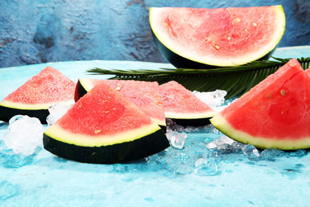 watermelon on blue background. juicy summer fruit in slices.