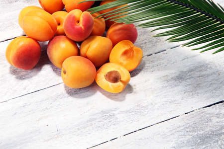 Bunch of fresh apricots on wooden table. fresh healthy food の写真素材