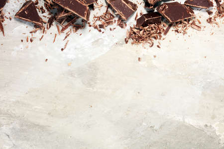 dark chocolate bars on stone table and broken pieces of cocoa.の写真素材