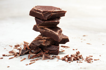dark chocolate bars on stone table and broken pieces of cocoa.の写真素材