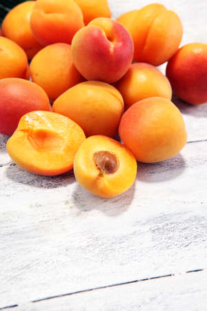 Bunch of fresh apricots on wooden table. fresh healthy food の写真素材