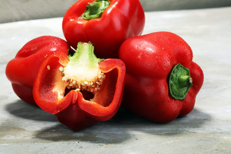 Fresh red bell pepper on grey background. raw vegetable.