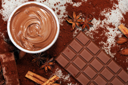 Chocolate bars on table with chocolate powder and swirl. Chocolate and nuts