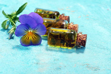 lavender oil and flower on blue background. Wellness health conceptの写真素材