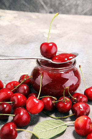 Rustic jar with cherry jam and fresh cherries, homemade preserves.の写真素材