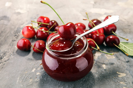 Rustic jar with cherry jam and fresh cherries, homemade preserves.の写真素材