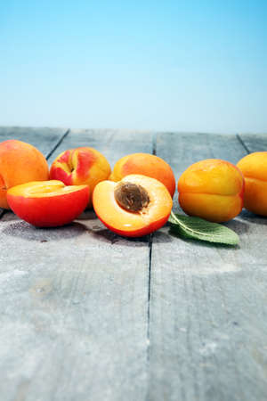 Delicious ripe apricots on wooden table. Fresh cut apricot fruits.の写真素材