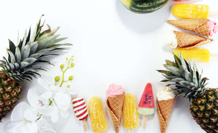Vanilla frozen yogurt or soft ice cream in waffle cone and Colorful with tropical fruitsの写真素材
