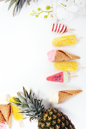 Vanilla frozen yogurt or soft ice cream in waffle cone and Colorful with tropical fruits