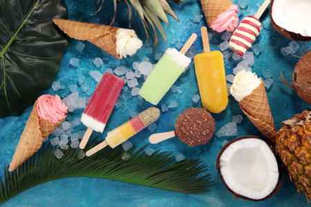 Vanilla frozen yogurt or soft ice cream in waffle cone and Colorful tropical fruitsの写真素材