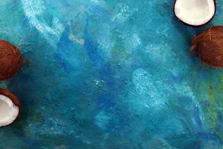 Ripe half cut coconut on a blue background.の写真素材