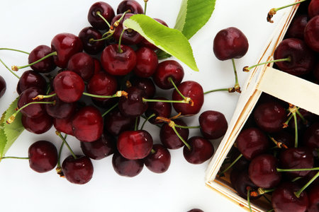 Cherry. Red fresh Cherries in a basket and a bunch of cherries on the table.
