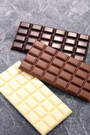chocolate in diffrent color. milk, dark and white chocolate bars.の写真素材