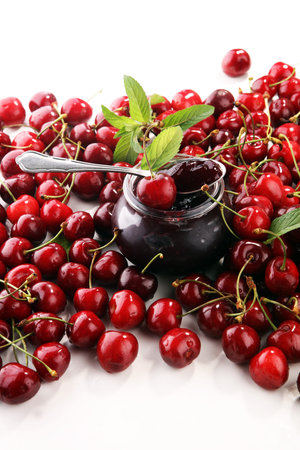 Rustic jar with cherry jam and fresh cherries, homemade preserves.の写真素材