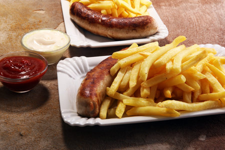 Grilled sausage served with french fries or fried potatoes with sausage.の写真素材