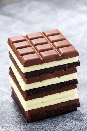chocolate in diffrent color. milk, dark and white chocolate bars.