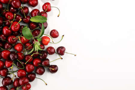 Cherry. Red fresh Cherries in bowl and a bunch of cherries on the table .の写真素材
