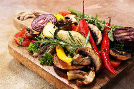 Grilled vegetables. Tomatoes, zucchini, bell pepper and fresh herbs. Vegan grill concept.の写真素材