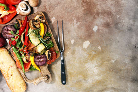 Grilled vegetables. Tomatoes, zucchini, bell pepper and fresh herbs. Vegan grill concept.の写真素材