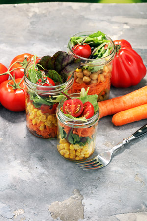 Homemade salad in glass jar with vegetables. Healthy food, diet, detox, clean eating and vegetarian concept.の写真素材