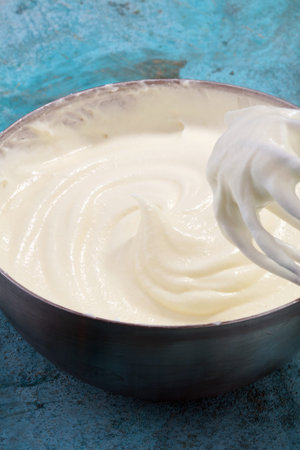 close up of a white whipped or sour cream in bowl