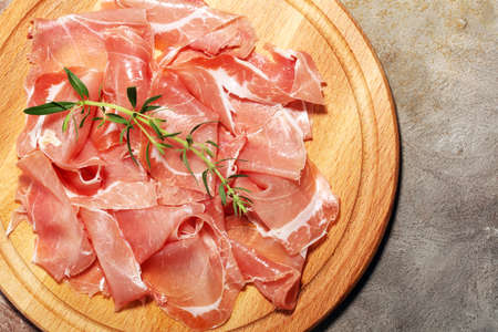 Italian prosciutto crudo or jamon with parsley. Raw ham.の写真素材