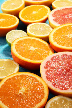 Citrus fruits with orange, lemon, grapefruit and lime on blue backgroundの写真素材