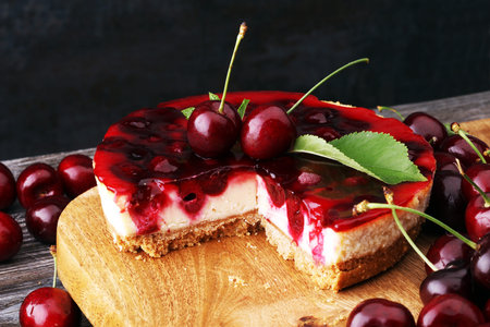 Home made cherry cake with vanilla and black cherries on wooden table