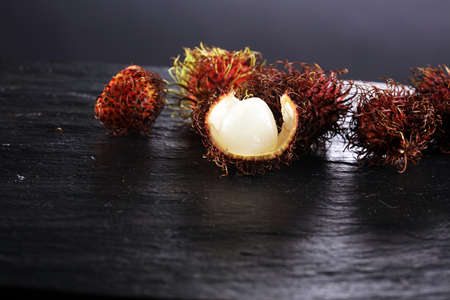 Rambutans fruit with leaf on table. Rambutan or hairy lychee.の写真素材
