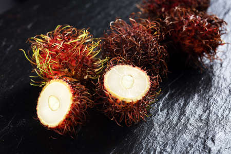 Rambutans fruit with leaf on table. Rambutan or hairy lychee.の写真素材