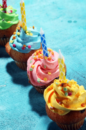 Tasty cupcakes on table. Birthday cupcake in rainbow colorsの写真素材