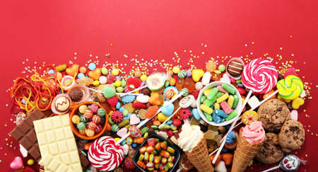 candies with jelly and sugar. colorful array of different childs sweets and treatsの写真素材