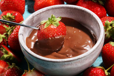Fondue with Melting chocolate or melted chocolate and strawberryの写真素材