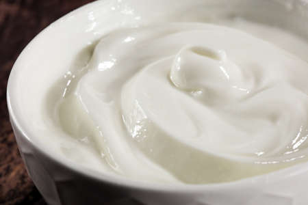 close up of a white whipped or sour cream in bowlの写真素材