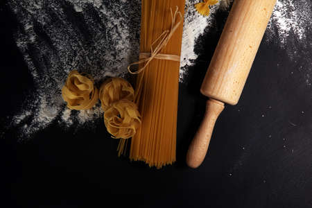 Various mix of pasta on rustic background. Making homemade pastaの写真素材