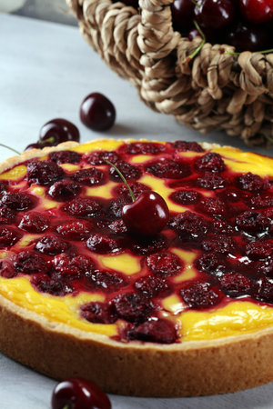 cherry cake and a bunch of cherries on table.