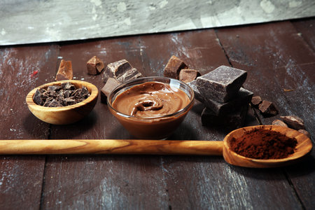 Melting chocolate  or melted chocolate with a chocolate swirl. Many stack and chips with powder