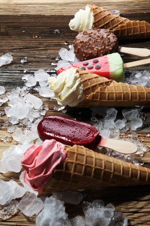 ice cream in waffle cone and strawberry, raspberry and chocolate softice cream and colorful...
