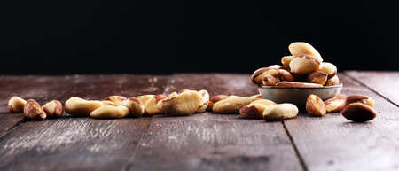 Para nuts on a rustic wooden table and para nuts in bowl.の写真素材