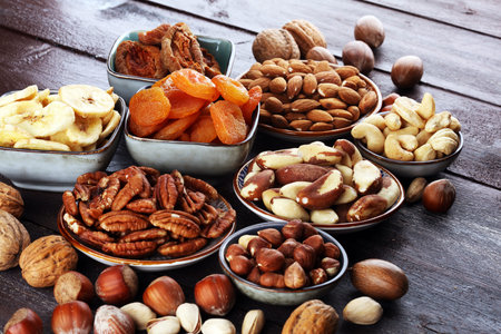Dried fruits and assorted nuts composition on rustic table.の写真素材