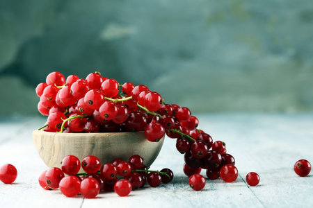 Fresh red currants on light rustic table. Healthy summer fruits.の写真素材