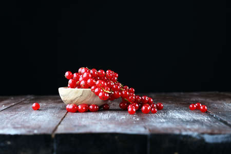 Fresh red currants on light rustic table. Healthy summer fruits.の写真素材