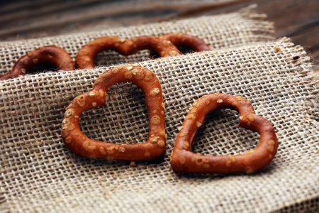 German heart spaped pretzels with salt close-up on the table.の写真素材