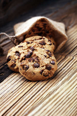 Chocolate cookies on wooden table. Chocolate chip cookies shotの写真素材