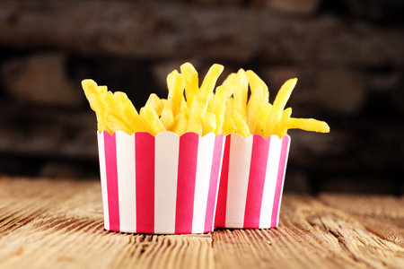Potatoes French Fries in Red and white Carton Package Box. Fast Foodの写真素材